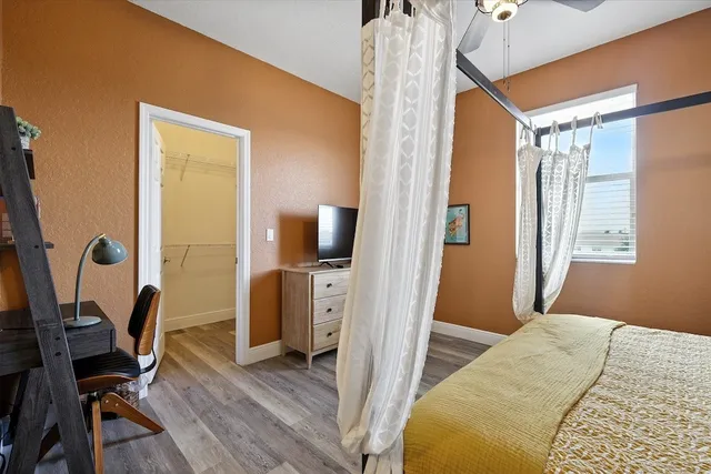 a bedroom with a bed and a flat screen tv