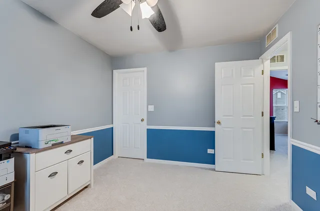 a kitchen with stainless steel appliances cabinets and wooden floor