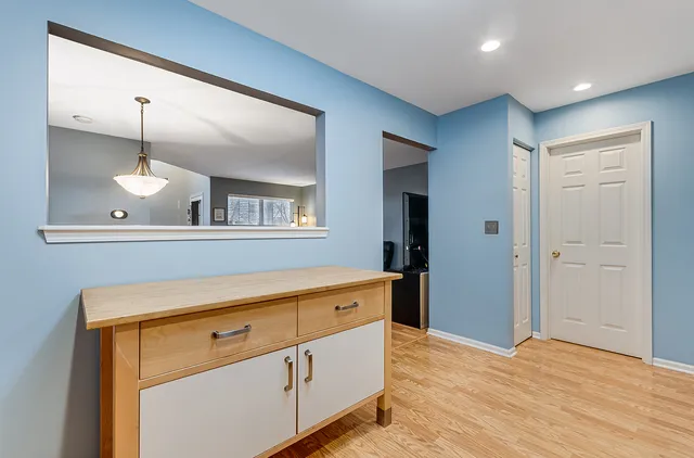 a view of a kitchen with a sink and wooden floor