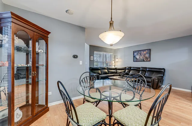 a view of a dining room with furniture and a chandelier