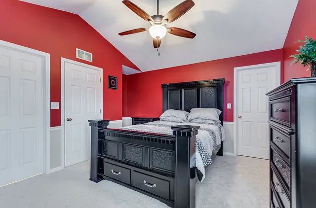 a bed sitting in a room next to a window