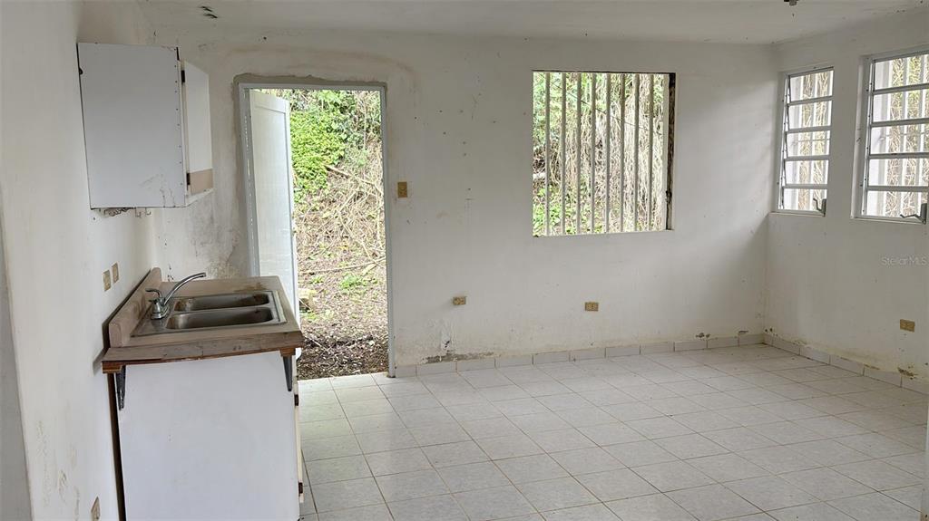 730 Carr Km Cayey, Cayey 00736 - Photo 5 of 17 a bathroom with a granite countertop sink a vanity and a window