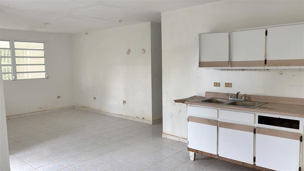 730 Carr Km Cayey, Cayey 00736 - Photo 6 of 17 a kitchen with granite countertop a sink cabinets and stainless steel appliances