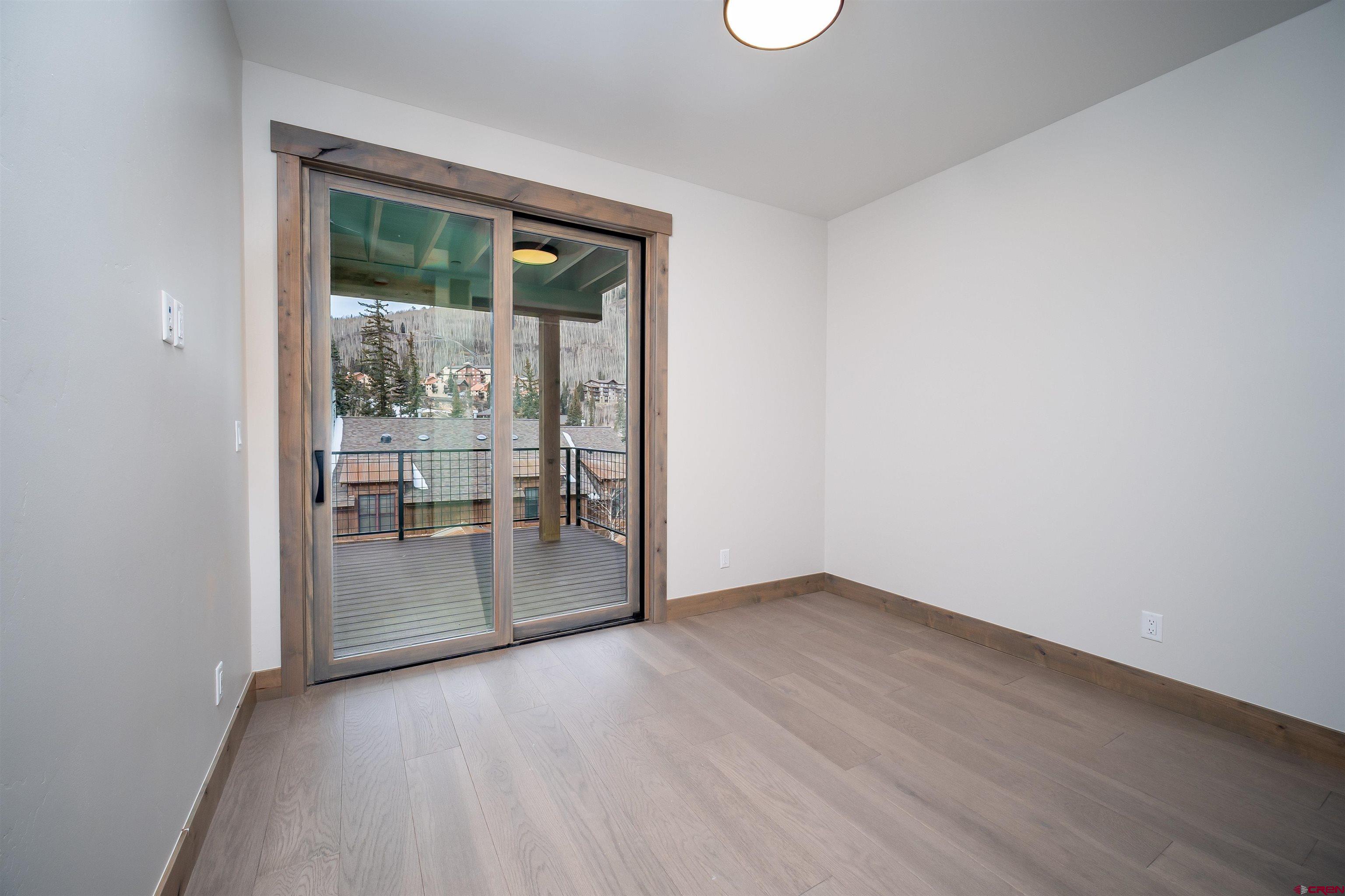 95 Travertine Trail Durango, CO 81301 - Photo 13 of 41 an empty room with wooden floor and a window