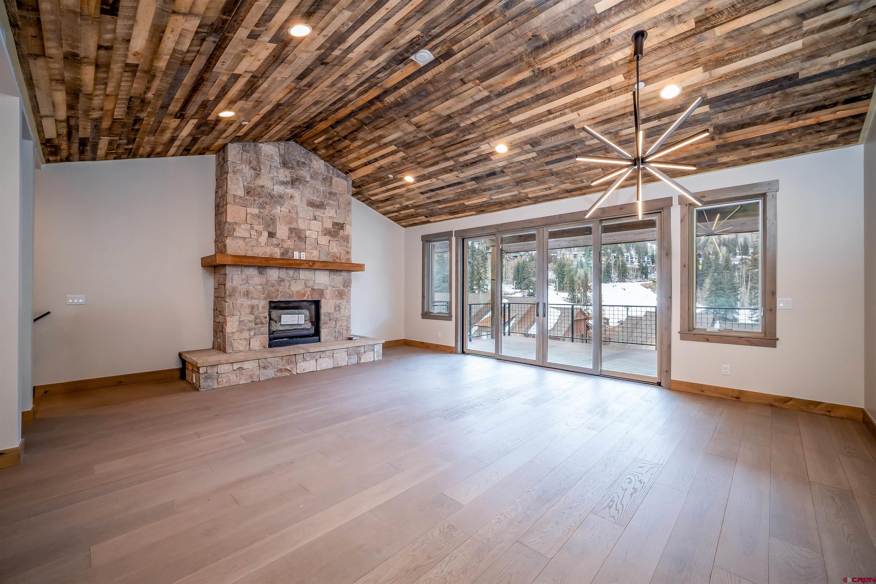 95 Travertine Trail Durango, CO 81301 - Photo 6 of 41 a view of an empty room with wooden floor and a fireplace