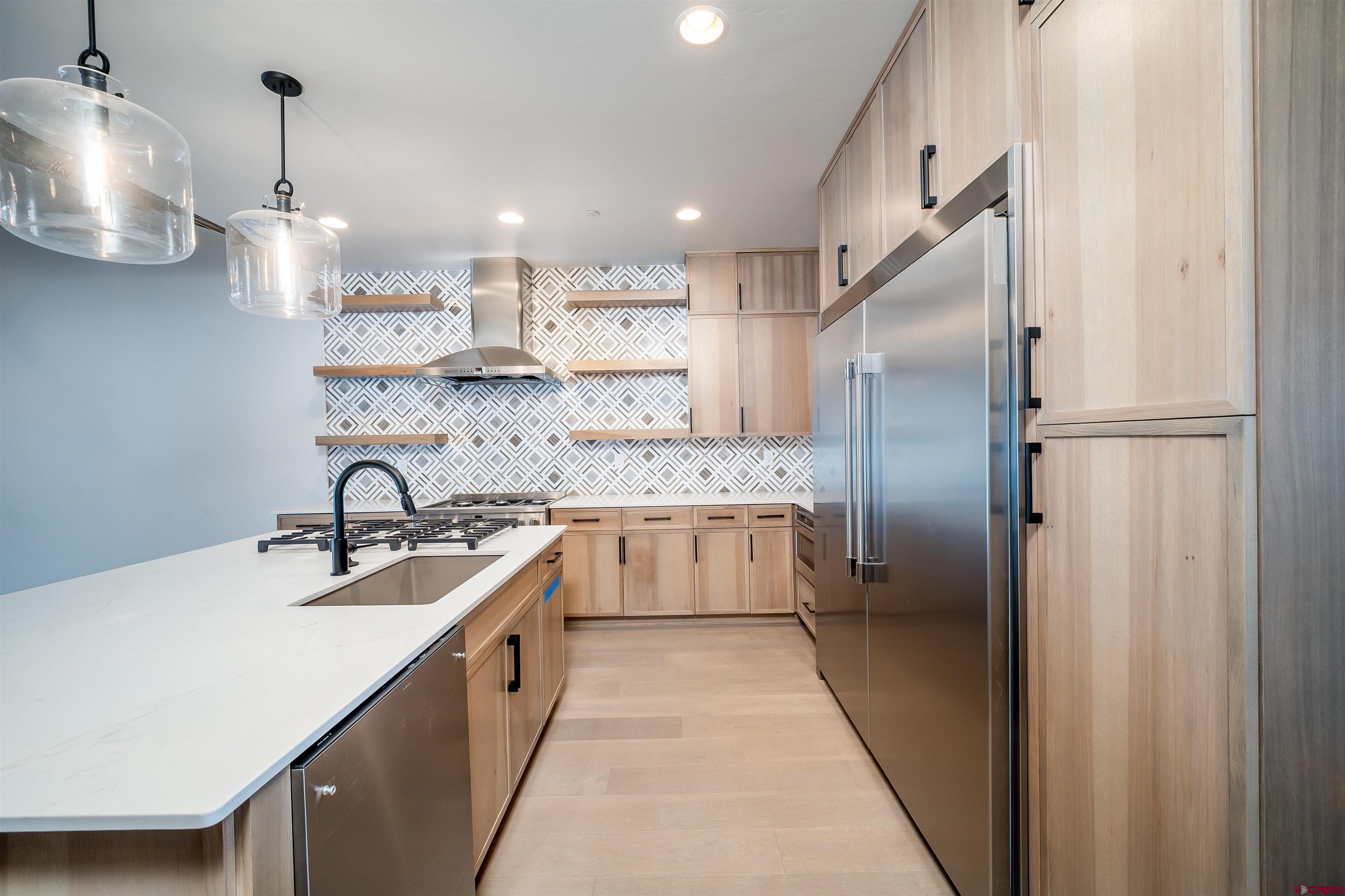 95 Travertine Trail Durango, CO 81301 - Photo 9 of 41 a large kitchen with a sink a counter top stainless steel appliances and cabinets