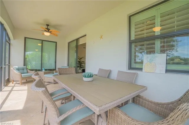 a lake view with a big yard and large trees