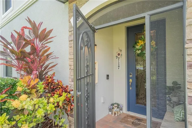 a living room with furniture a flat screen tv and a large window