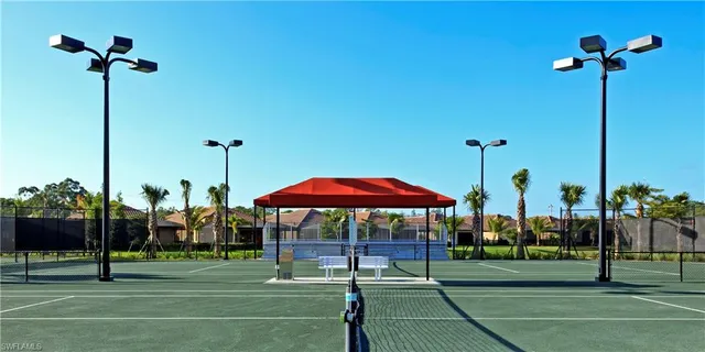 a view of a white building with a swimming pool