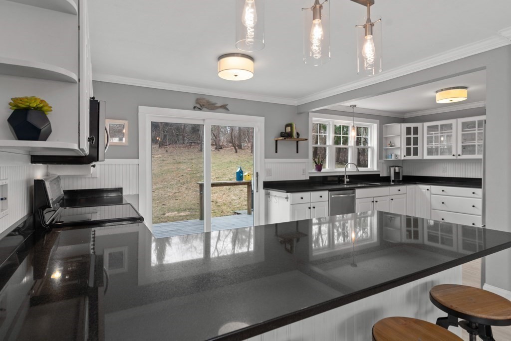 15 Scotland Road Newbury, MA 01951 - Photo 12 of 34 a kitchen with stainless steel appliances granite countertop a stove top oven a sink a counter space and cabinets