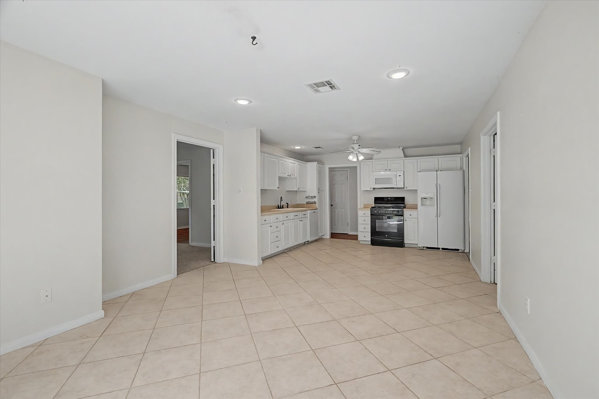 413 Farrer Street Angleton, TX 77515 - Photo 18 of 43 an empty room with kitchen appliances and a window