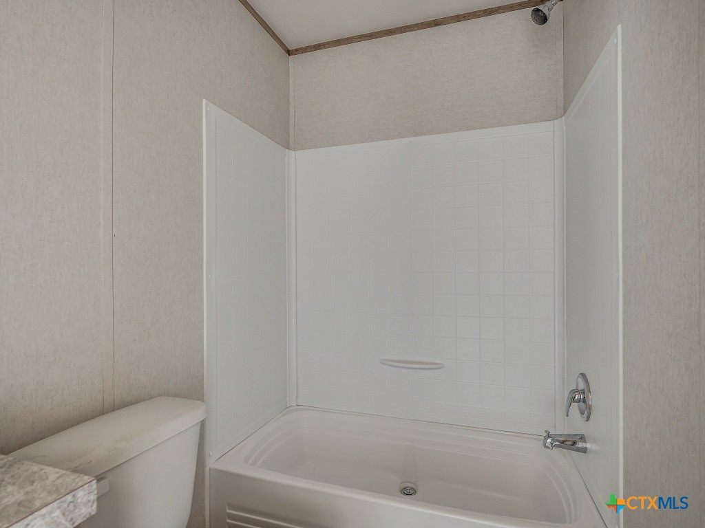 352 Trammel Road Eddy, TX 76524 - Photo 7 of 11 a bathroom with a bathtub and a toilet