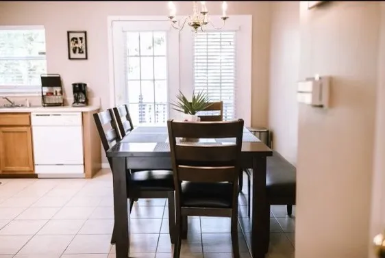 a dining room with furniture and window
