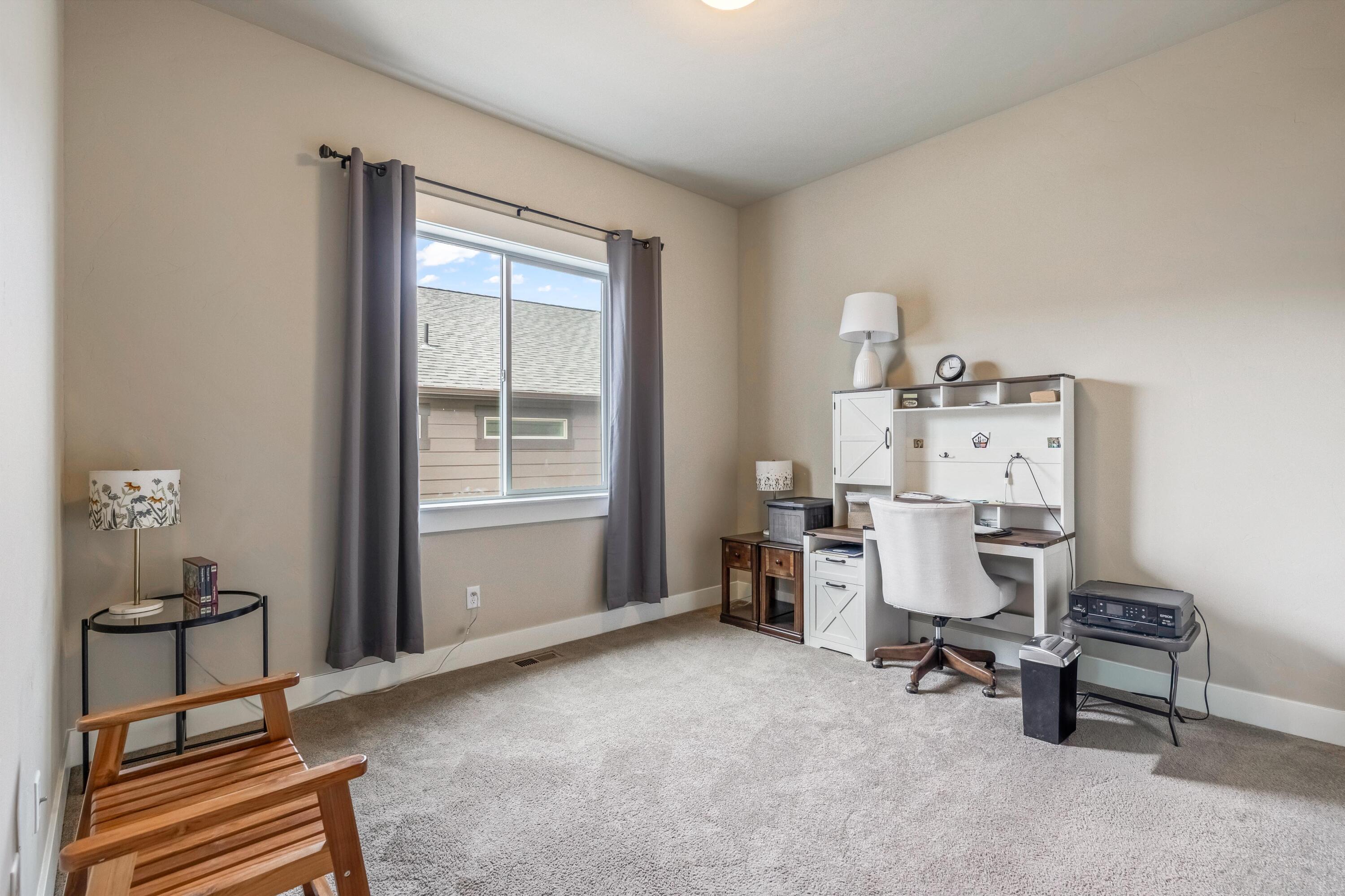 2375 Northwest Majestic Ridge Drive Bend, OR 97703 - Photo 13 of 28 a view of a workspace with furniture and a window