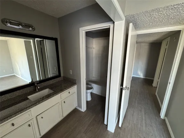 a bathroom with a sink a mirror and a shower