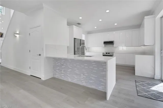 a kitchen with kitchen island cabinets and oven