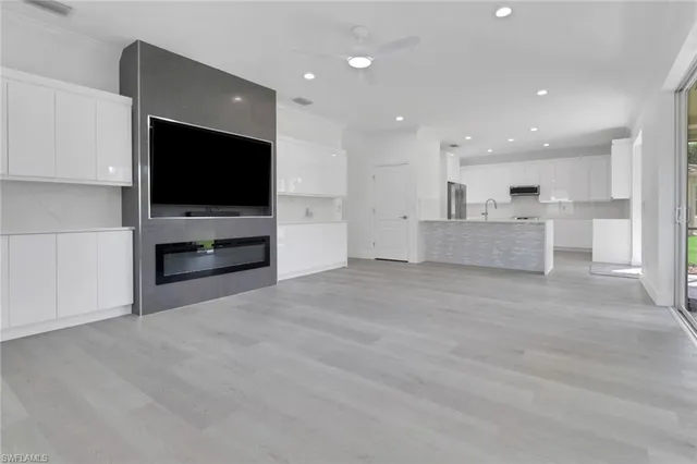 a view of kitchen with refrigerator stove and a flat screen tv