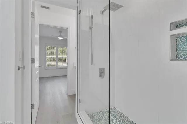 a view of a bathroom with a glass shower door
