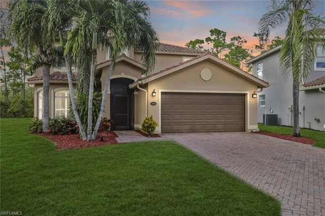 a front view of a house with a yard and garage