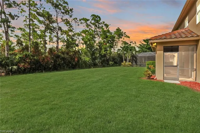 a view of a house with a backyard