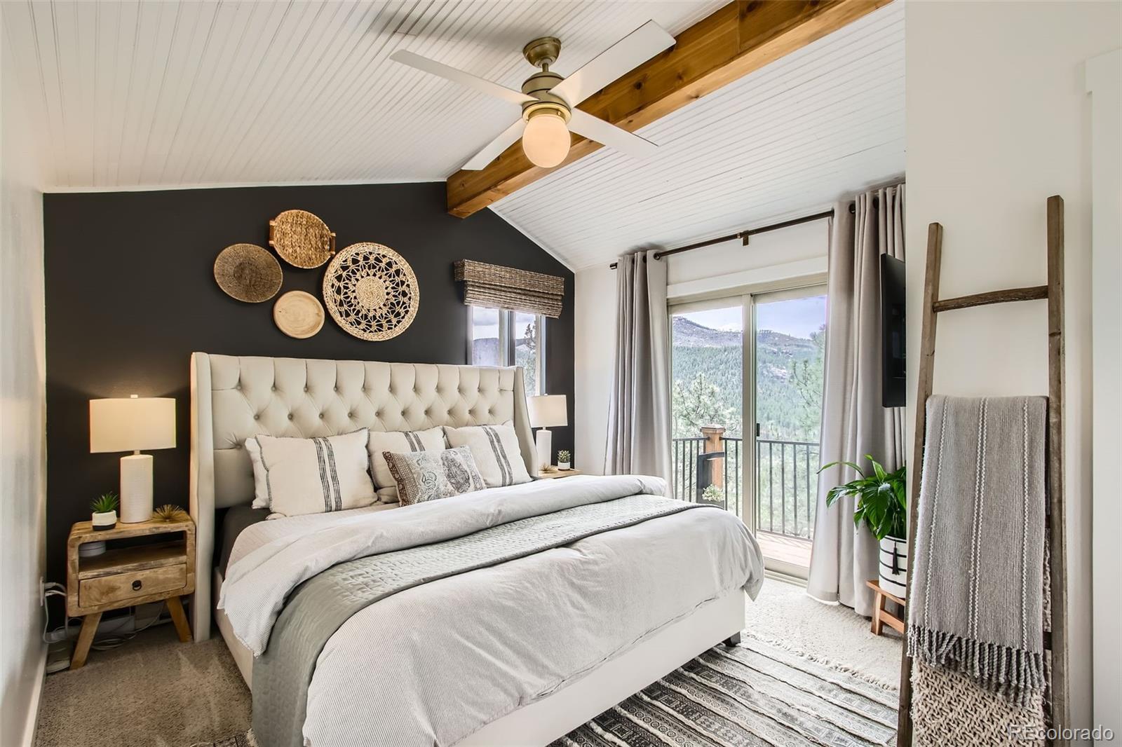 16626 Ouray Road West Pine, CO 80470 - Photo 15 of 50 a bedroom with a bed and a large window