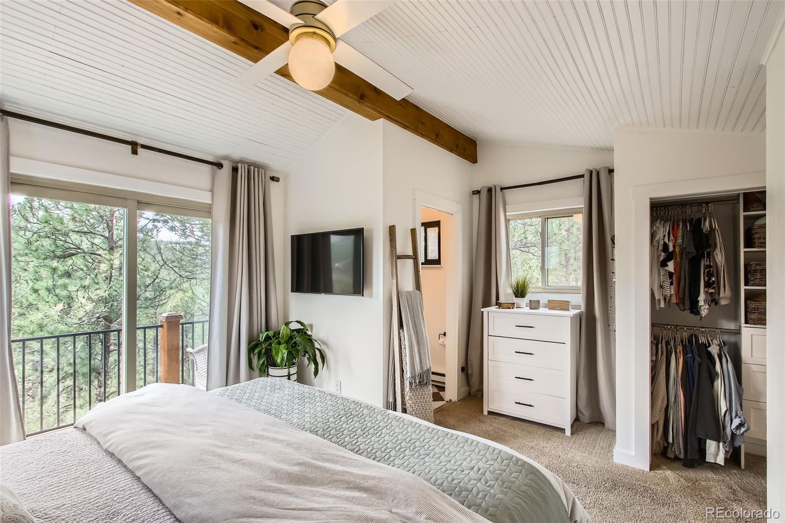 16626 Ouray Road West Pine, CO 80470 - Photo 16 of 50 a bedroom with a bed and a large window