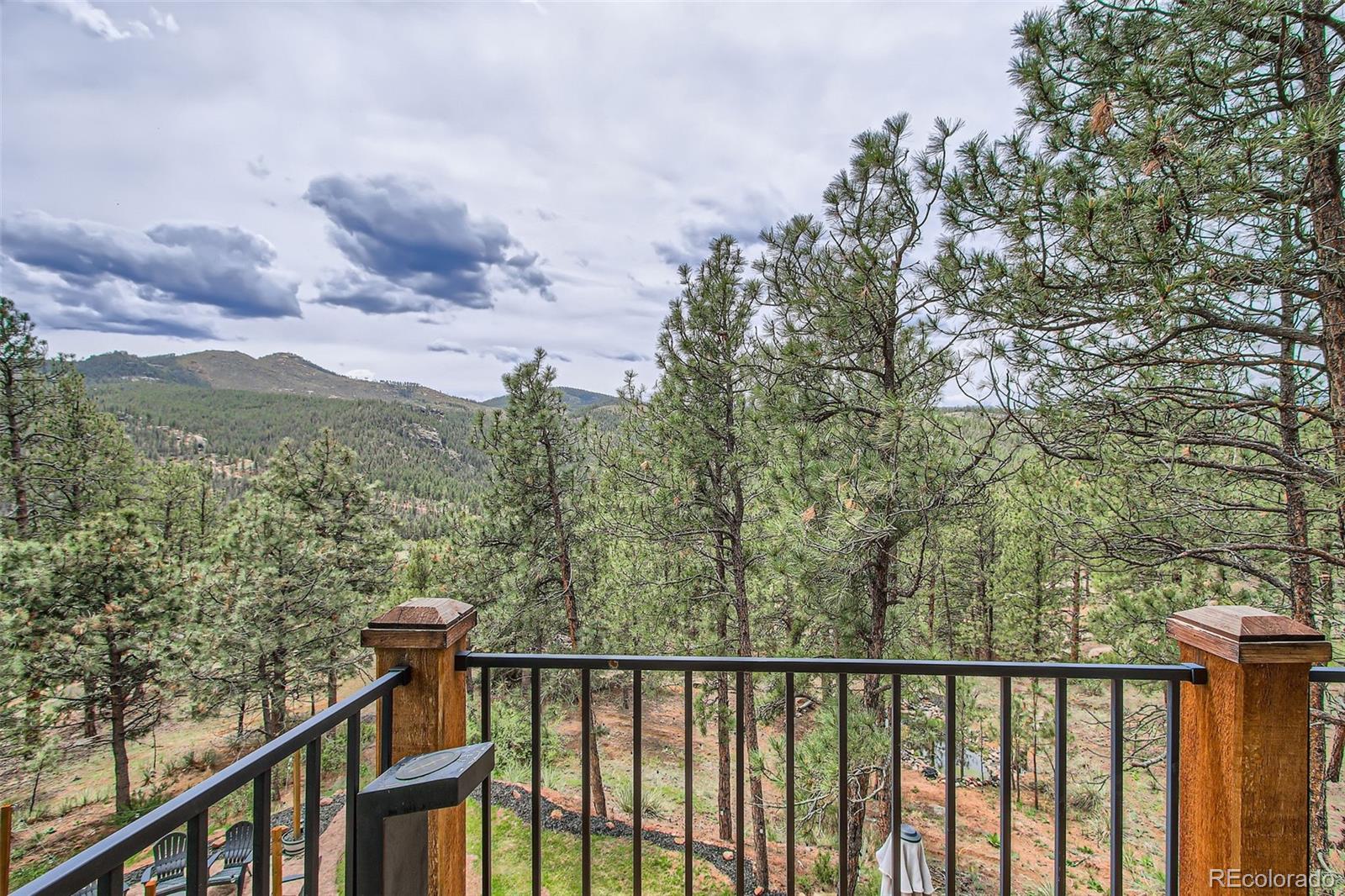16626 Ouray Road West Pine, CO 80470 - Photo 18 of 50 a view of a balcony with wooden fence and floor
