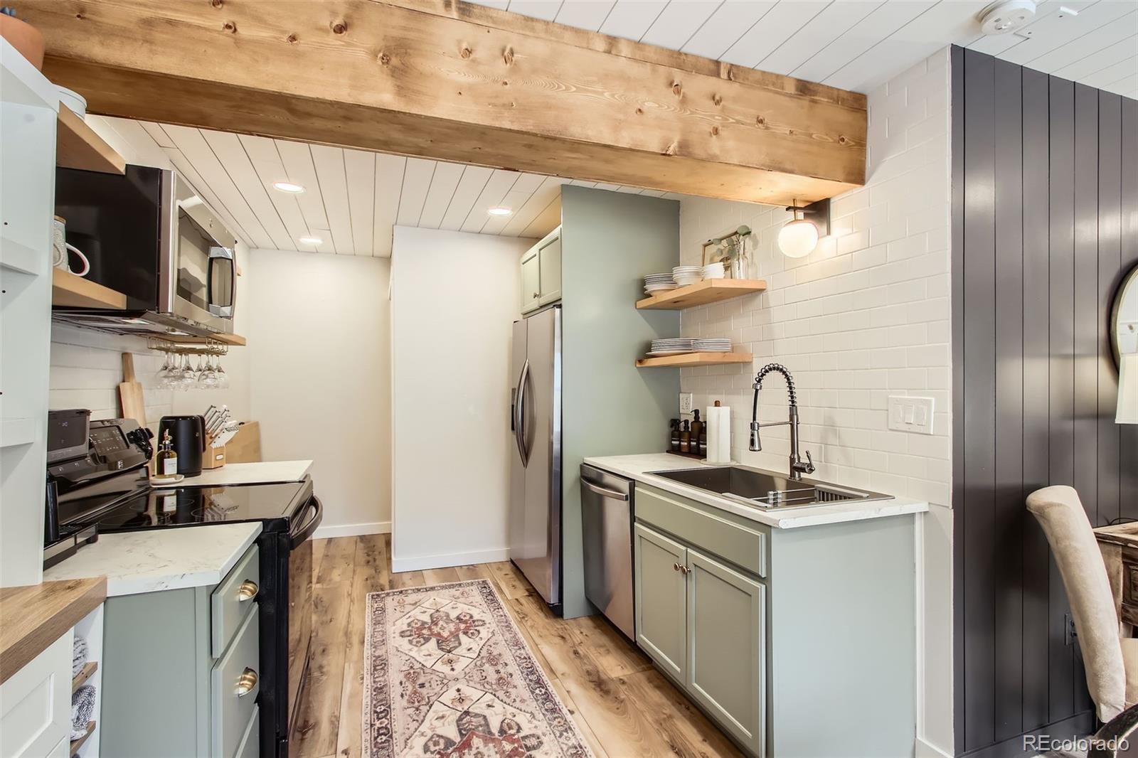 16626 Ouray Road West Pine, CO 80470 - Photo 29 of 50 a kitchen with stainless steel appliances granite countertop a sink stove and refrigerator