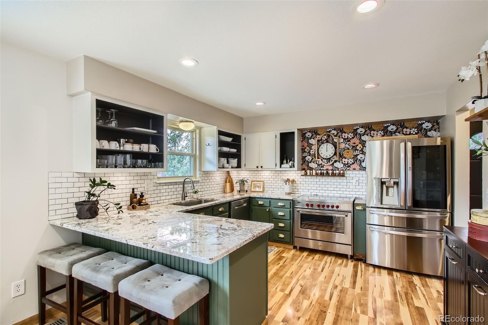 16626 Ouray Road West Pine, CO 80470 - Photo 7 of 50 a kitchen with stainless steel appliances granite countertop a sink stove and refrigerator