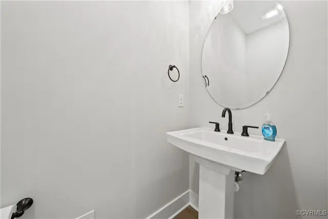 a bathroom with a sink and mirror