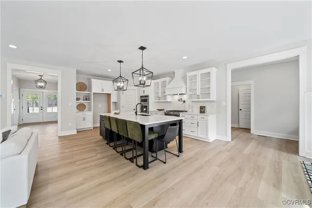 a large white kitchen with a table and chairs