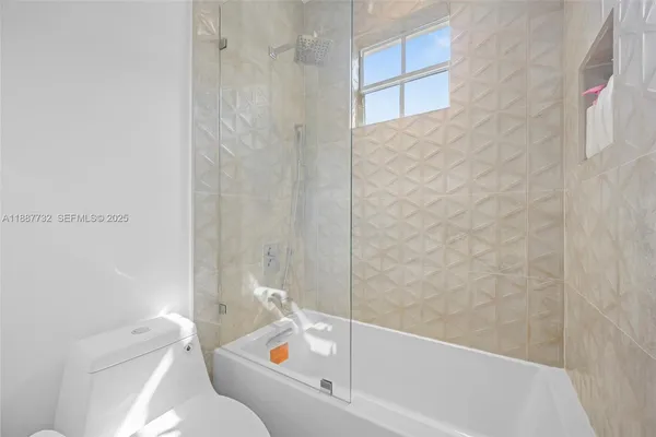 a bathroom with a bathtub and toilet
