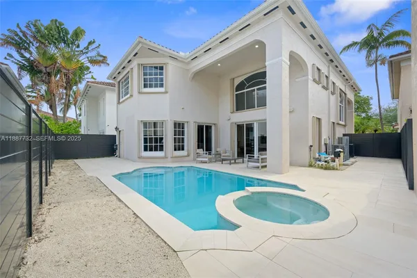 a swimming pool with outdoor seating