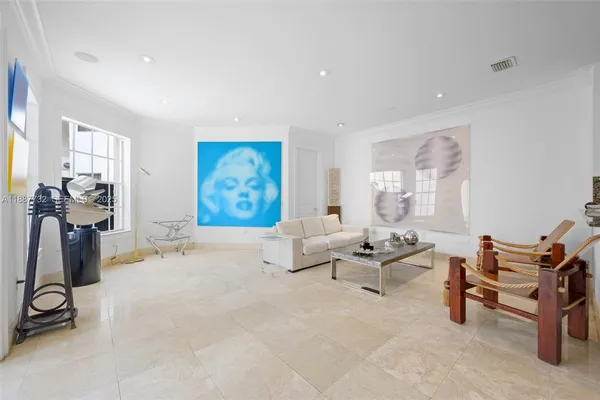 a bedroom with furniture and a flat screen tv