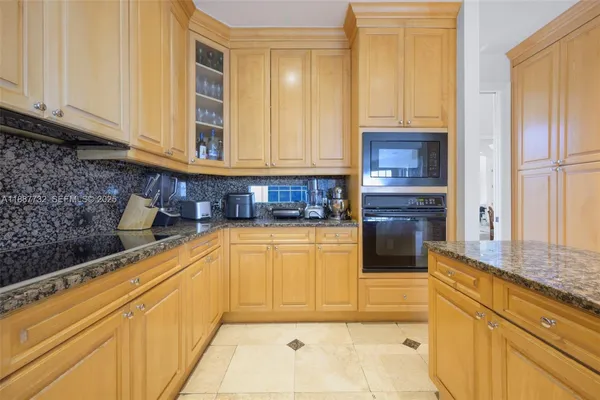 a kitchen with stainless steel appliances granite countertop a refrigerator and cabinets