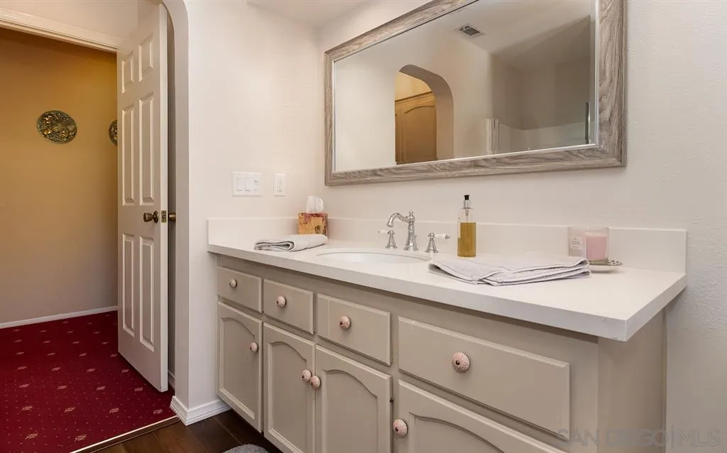 2444 Crestview Estates Place Escondido, CA 92027 - Photo 15 of 25 a bathroom with a sink and a mirror