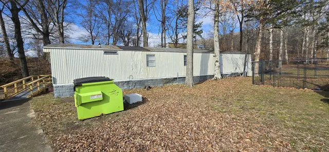 a white bench sitting in front of a house