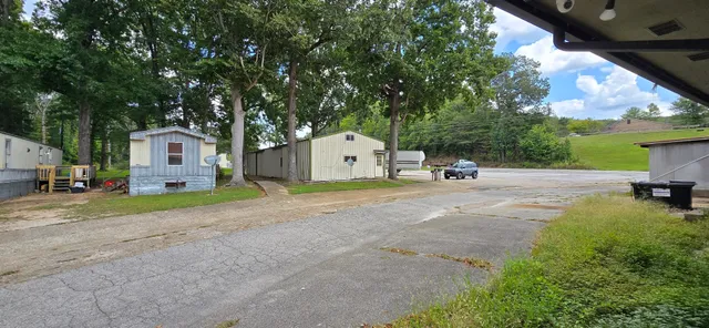a white house that has a tree in front of it