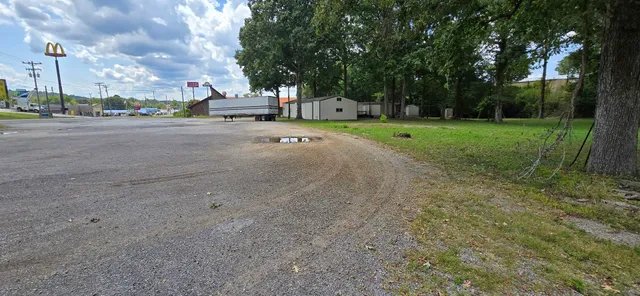 a view of road with grass and a trees