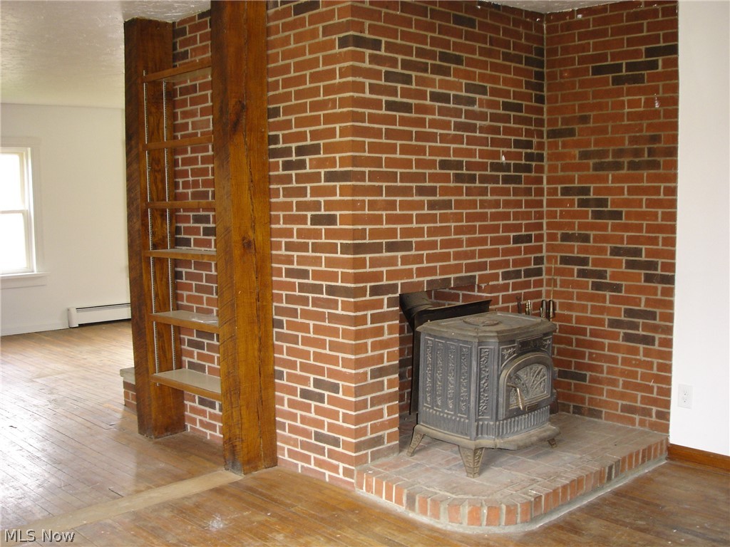 9733 Madison Road Montville, OH 44064 - Photo 10 of 31 Wood burning stove in family room.