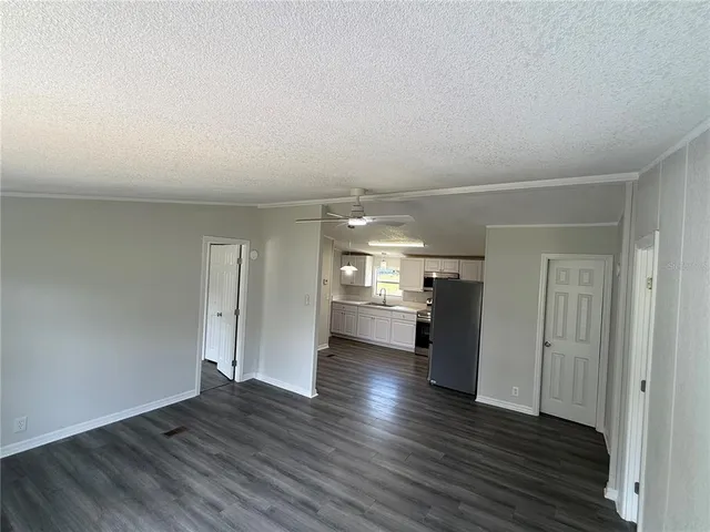 a view of a kitchen with wooden floor and a sink