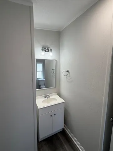a bathroom with a sink a toilet and mirror
