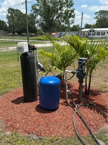 a view of a backyard with plants and a patio