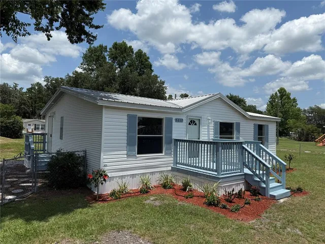a view of a house with a wooden deck