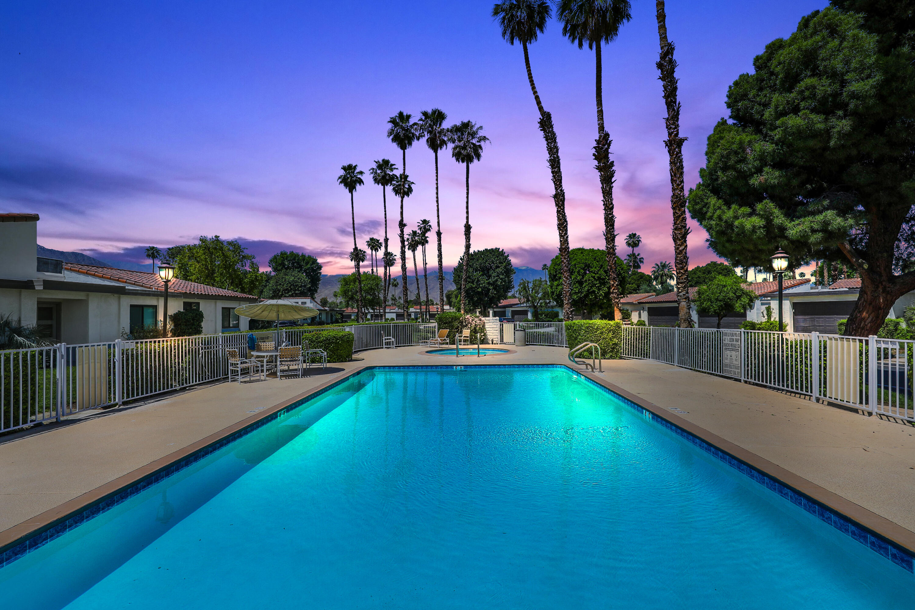 39 Leon Way Rancho Mirage, CA 92270 - Photo 25 of 30 a view of a swimming pool with a table and chairs