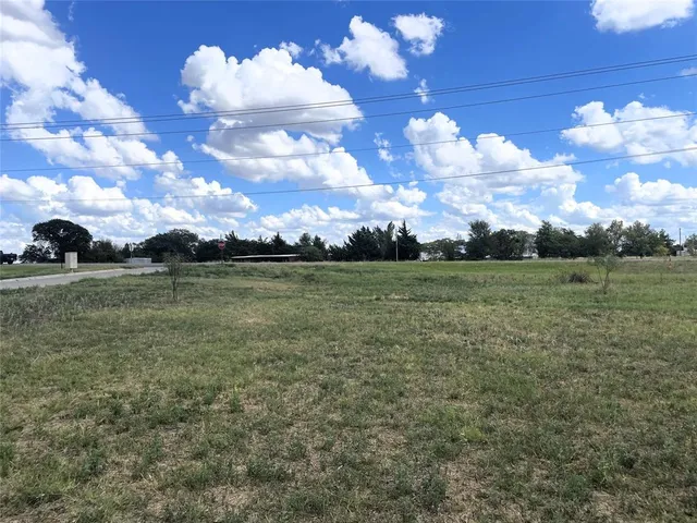 a view of a big yard of grass and mountain view