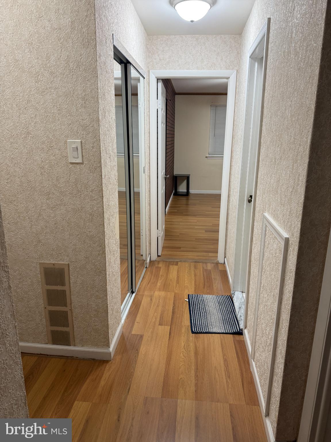 5107 Bay Road Bensalem, PA 19020 - Photo 12 of 23 Inviting hallway with warm wooden floors.