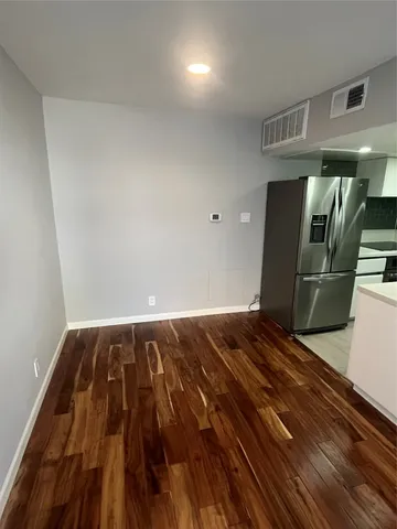a view of a room with wooden floor
