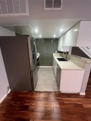 a room with wooden floor and utility