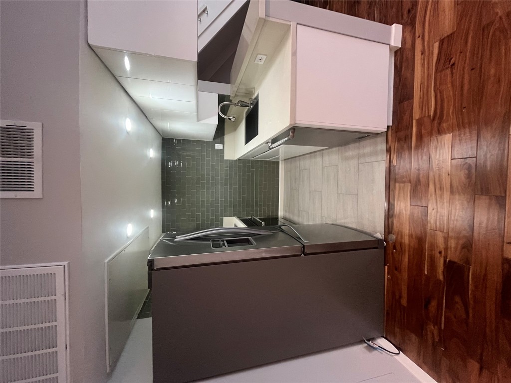 3110 Red River Street, Unit 216 Austin, TX 78705 - Photo 12 of 22 a room with wooden floor and utility